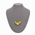 Model wearing Ysaline Baltic amber pendant necklace in lemon yellow amber — handcrafted in Lithuania by AMBER999
